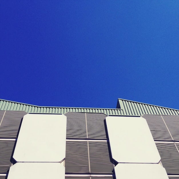 A close-up of high-efficiency solar panels on a US home roof, highlighting the panel design and the surrounding blue sky.