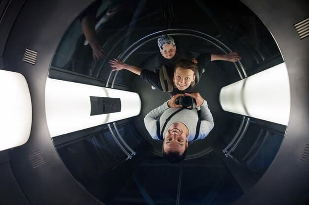 A group of space tourists inside a Virgin Galactic spacecraft cabin, experiencing weightlessness and looking out the window at the Earth below. They are smiling and appear excited.