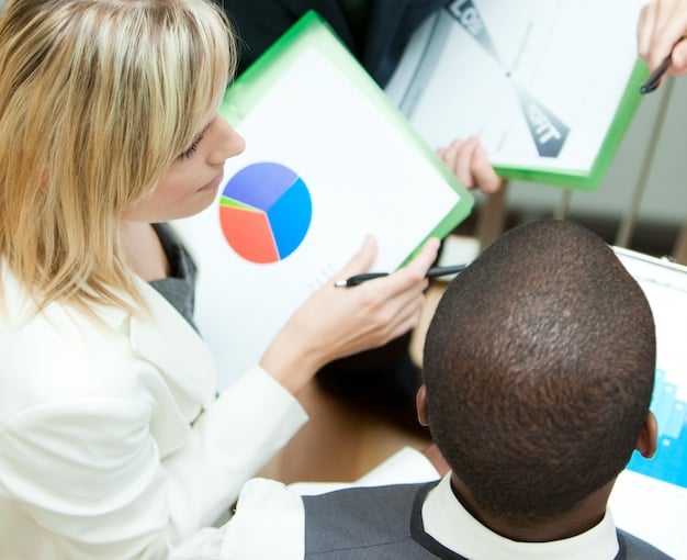 A close-up shot of a teacher using a dashboard to monitor the progress of individual students in an adaptive learning program. The dashboard displays various metrics such as completion rates, accuracy scores, and areas where students are struggling.