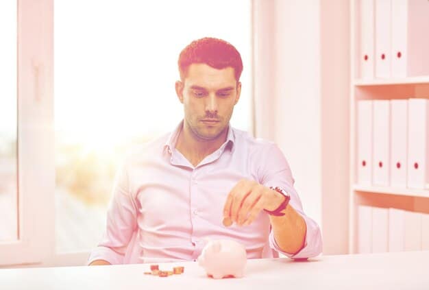 A person putting money into a piggy bank, symbolizing traditional savings methods and the accumulation of small amounts over time.