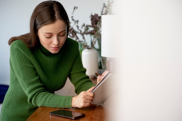 A person using a budget planner to track expenses and allocate funds for paying down credit card debt. A credit card with a low balance is shown in the foreground, symbolizing successful debt management.