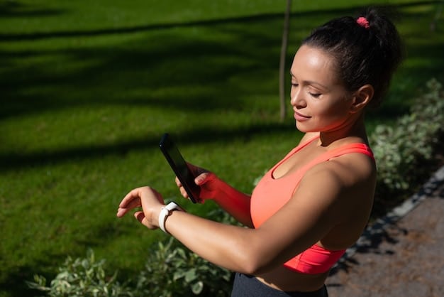 A person happily using a fitness tracker while jogging outdoors, illustrating the integration of technology in modern wellness programs.