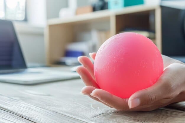 A close-up of a person's hands holding a stress ball in a dimly lit office. The image emphasizes the role of EAPs in helping employees manage stress and maintain their mental health.